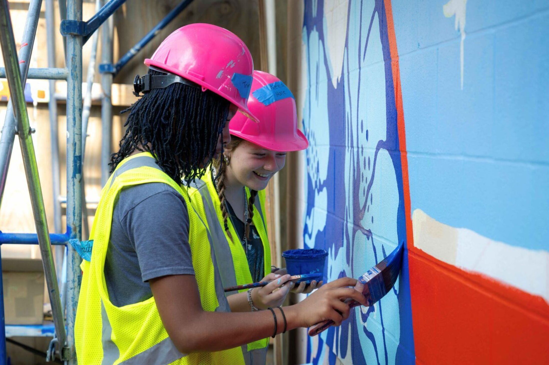 students painting mural