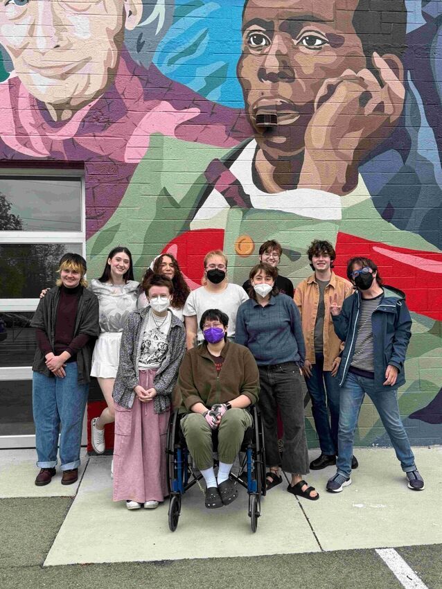 patrons in front of mural